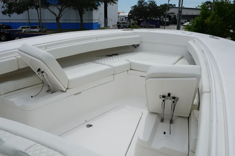 Slide: The Image of 2027 Regulator 31 boat interior with white cushioned seating and storage compartments. - 14