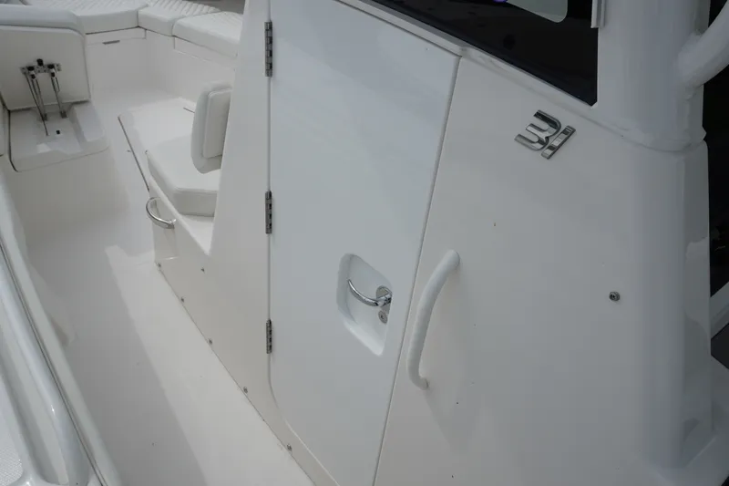 Slide: The Image of 2027 Regulator 31 boat interior with sleek white seating and modern design. - 17