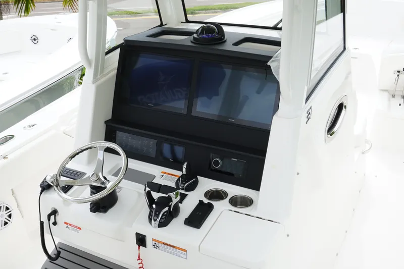 Slide: The Image of Helm of 2027 Regulator 31 boat with modern controls and navigation screens. - 8