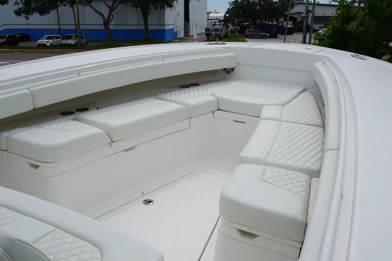 Slide: The Image of Luxurious seating area on a 2027 Regulator 31 boat, featuring white quilted cushions. - 13