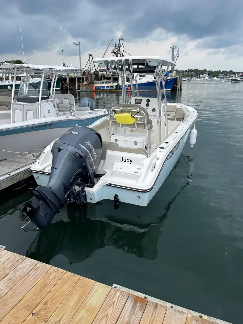 The Image of A 2024 Key West 239 FS boat docked. It features an outboard motor. - 0