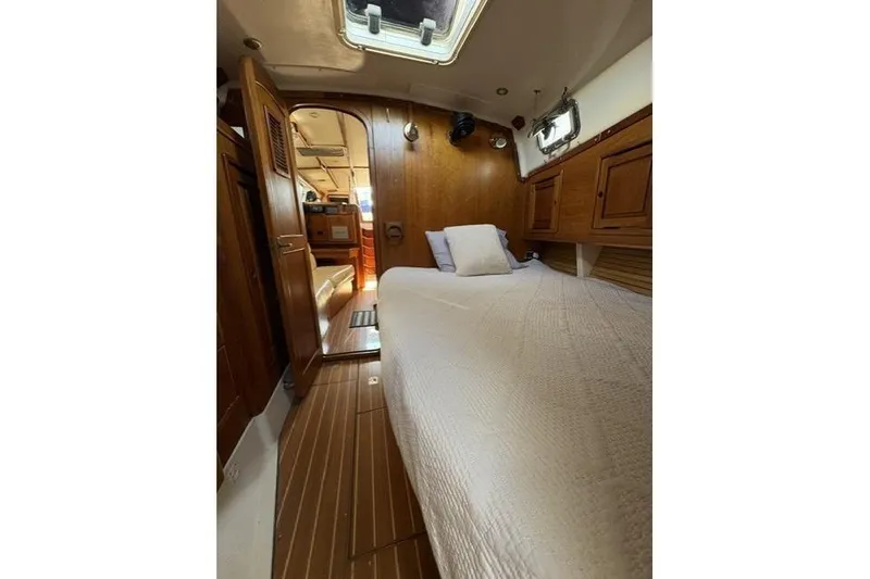 Slide: The Image of Interior cabin of 2002 Saga 43 yacht with wooden finish and cozy bedding. - 27