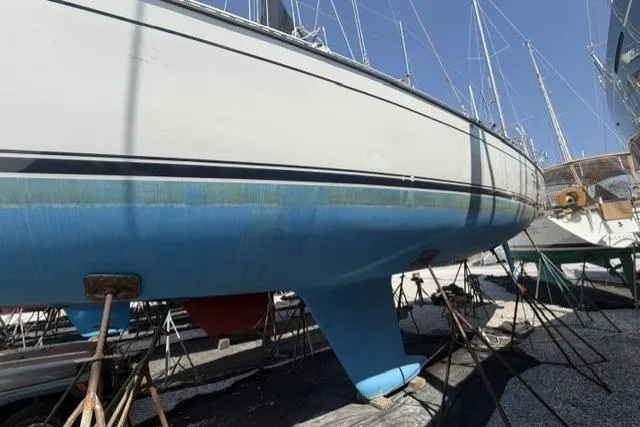 Slide: The Image of 2002 Saga 43 sailboat on stands, blue hull, in a boatyard. - 42