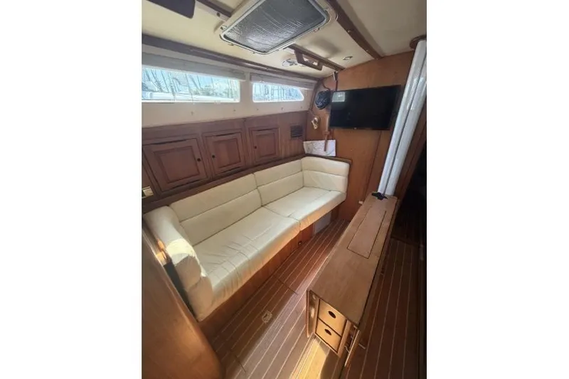 Slide: The Image of Interior of 2002 Saga 43 yacht with cozy seating and wooden cabinetry. - 25