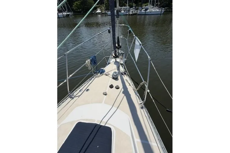 Slide: The Image of Deck view of a 2002 Saga 43 sailboat docked on calm water. - 12