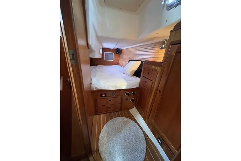 Slide: The Image of Cozy cabin interior of 2002 Saga 43 yacht with wooden furnishings and bed. - 32