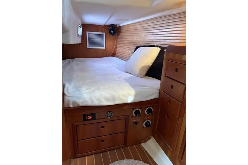 Slide: The Image of Cozy cabin interior of 2002 Saga 43 yacht with wooden finish and comfortable bedding. - 33