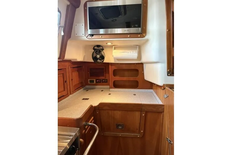 Slide: The Image of Interior of 2002 Saga 43 yacht with wooden cabinetry and modern amenities. - 15