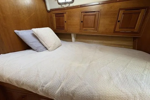 Slide: The Image of Cozy cabin bed in 2002 Saga 43 yacht with wooden storage cabinets. - 30