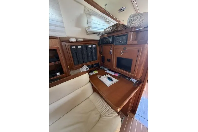 Slide: The Image of Interior of 2002 Saga 43 yacht with navigation station and wooden cabinetry. - 23