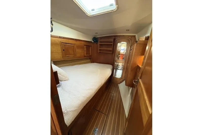 Slide: The Image of Cozy cabin interior of 2002 Saga 43 yacht with wooden furnishings and skylight. - 26