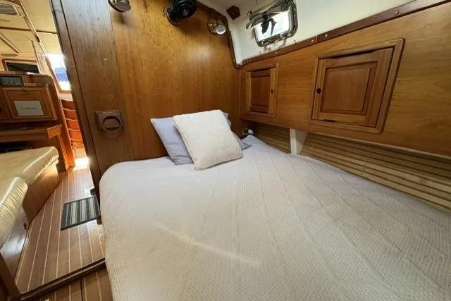 Slide: The Image of Cozy cabin interior of 2002 Saga 43 sailboat with wooden finish and comfortable bedding. - 29