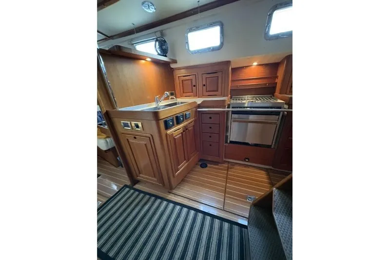 Slide: The Image of Luxurious wooden interior of 2002 Saga 43 yacht kitchen with modern appliances. - 17