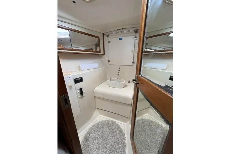 Slide: The Image of Interior of 2002 Saga 43 yacht bathroom with mirror and cushioned seat. - 35