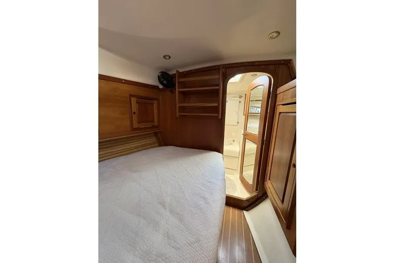 Slide: The Image of Cozy cabin interior of 2002 Saga 43 yacht with wooden furnishings and bed. - 31