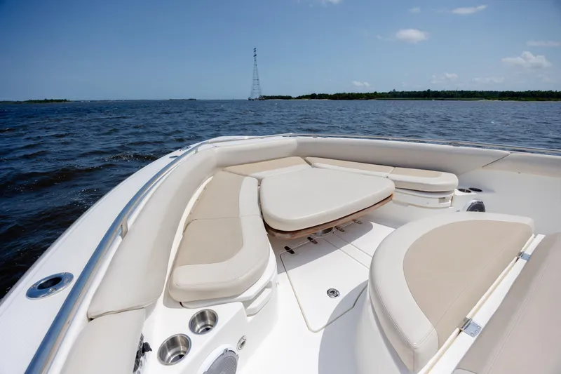 Slide: The Image of 2017 Boston Whaler 420 Outrage boat interior with cushioned seating on open water. - 59