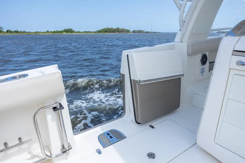 Slide: The Image of 2017 Boston Whaler 420 Outrage boat interior with open door, overlooking water. - 48