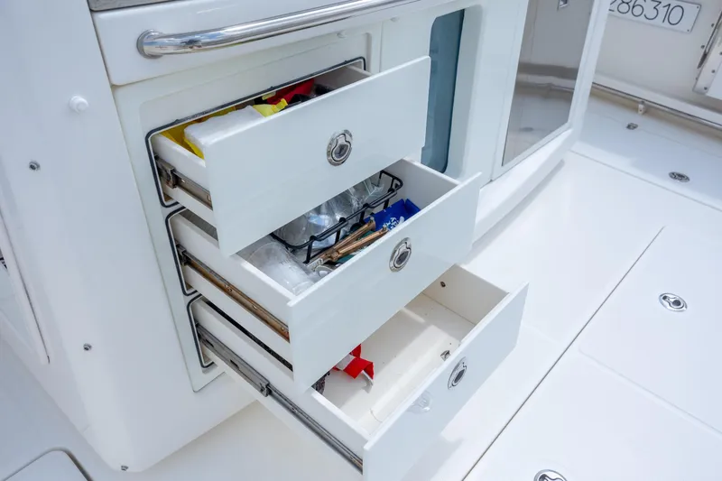 Slide: The Image of Open storage drawers on a 2017 Boston Whaler 420 Outrage boat deck. - 46