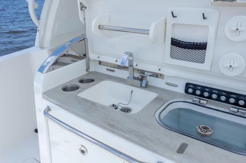 Slide: The Image of 2017 Boston Whaler 420 Outrage boat sink and control panel detail. - 44