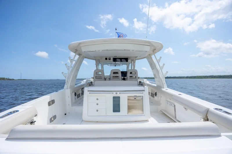 Slide: The Image of 2017 Boston Whaler 420 Outrage boat on open water, showcasing spacious deck and seating. - 39