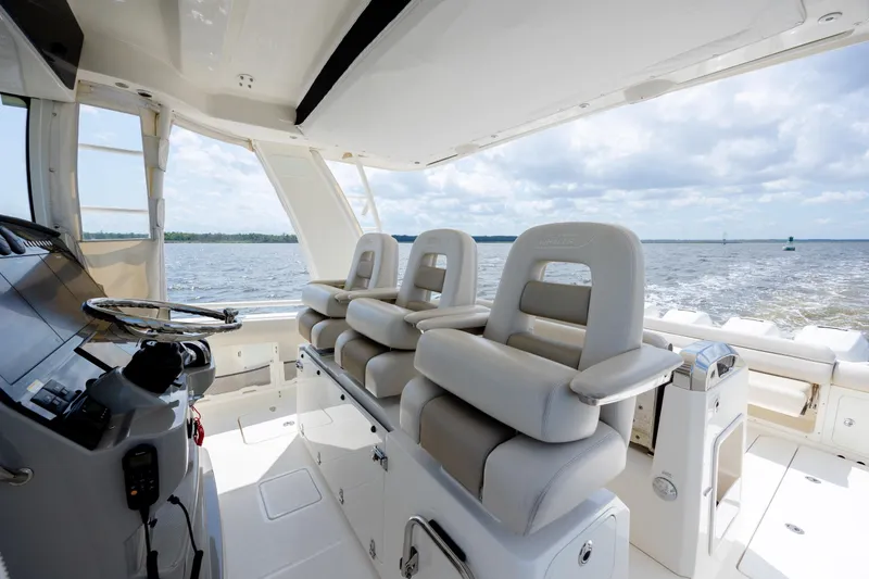 Slide: The Image of 2017 Boston Whaler 420 Outrage helm with luxurious seating and ocean view. - 22