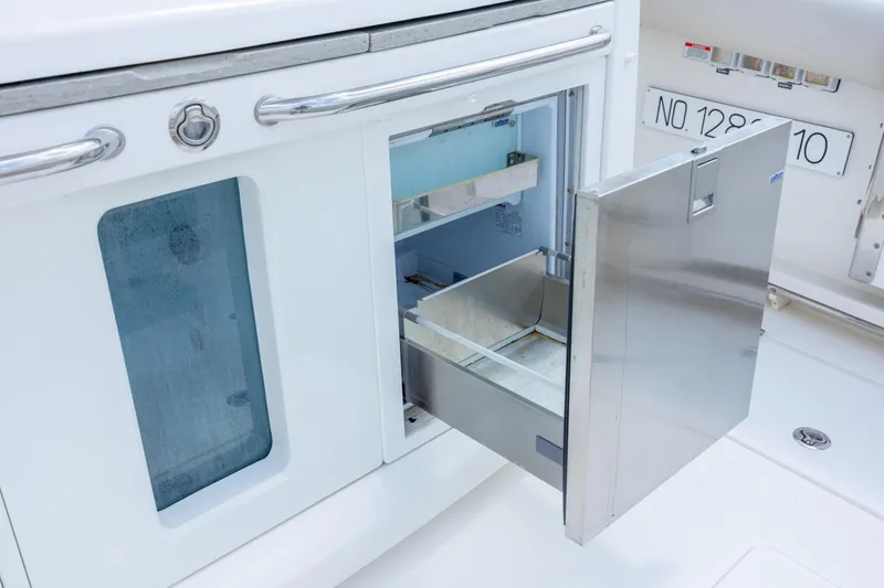 Slide: The Image of Open stainless steel drawer on 2017 Boston Whaler 420 Outrage boat, showcasing storage space. - 47