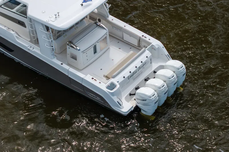Slide: The Image of 2017 Boston Whaler 420 Outrage with four Mercury outboard engines on water. - 8