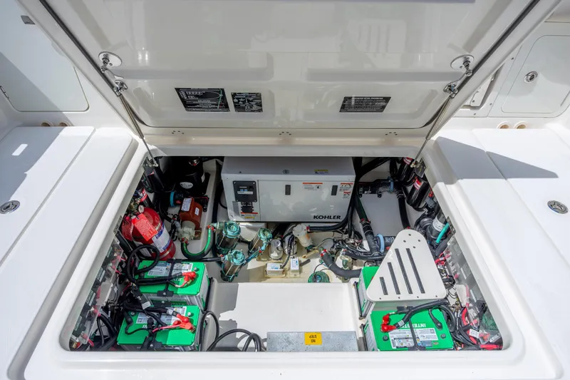 Slide: The Image of Engine compartment of a 2017 Boston Whaler 420 Outrage with Kohler generator and batteries. - 49