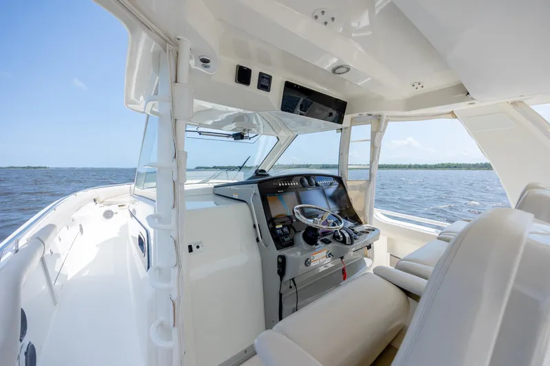 Slide: The Image of 2017 Boston Whaler 420 Outrage helm with ocean view, showcasing luxury and advanced navigation. - 19