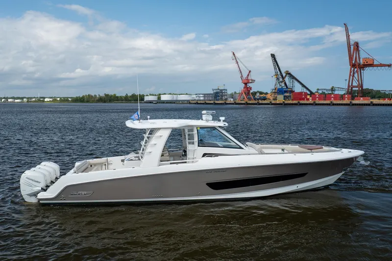 Slide: The Image of 2017 Boston Whaler 420 Outrage boat on water near industrial port. - 5