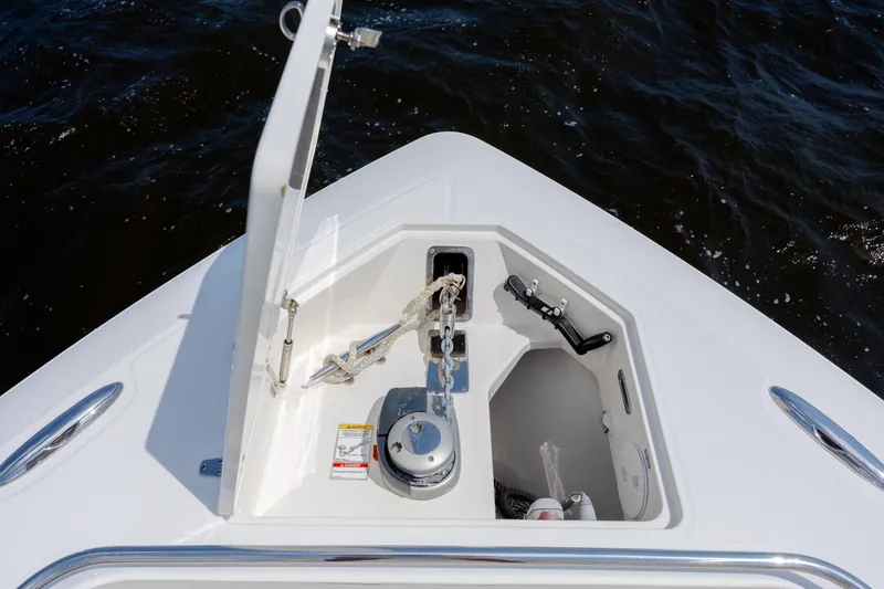 Slide: The Image of Bow anchor compartment of 2017 Boston Whaler 420 Outrage, open on calm water. - 65