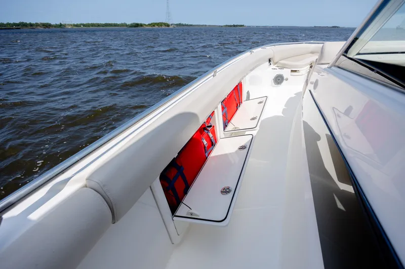 Slide: The Image of 2017 Boston Whaler 420 Outrage boat deck with storage compartments and life jackets. - 57
