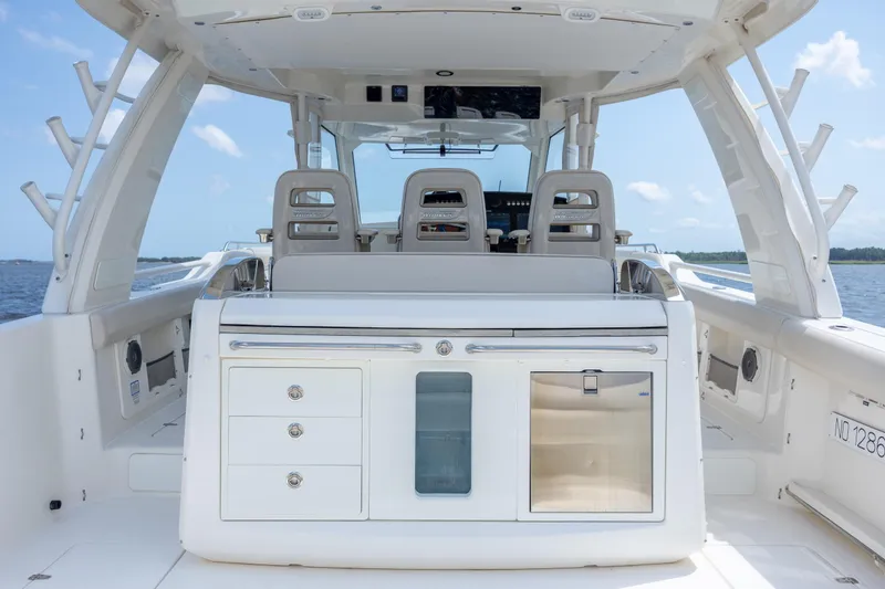 Slide: The Image of 2017 Boston Whaler 420 Outrage boat interior with seating and storage, on open water. - 40