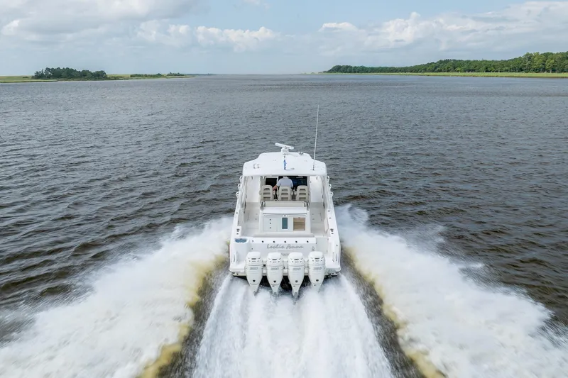 Slide: The Image of 2017 Boston Whaler 420 Outrage cruising on open water, rear view. - 18