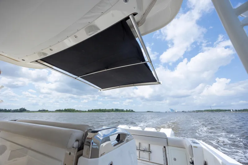 Slide: The Image of Boston Whaler 420 Outrage 2017 boat with retractable sunshade on open water. - 23