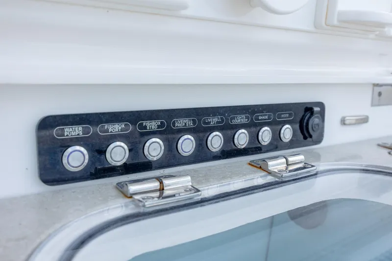 Slide: The Image of Control panel on a 2017 Boston Whaler 420 Outrage boat, featuring various function buttons. - 45