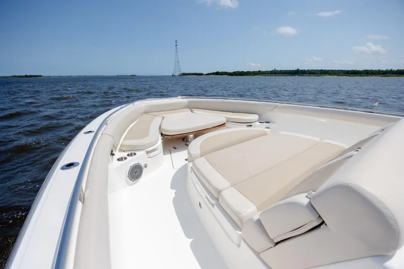 Slide: The Image of 2017 Boston Whaler 420 Outrage boat interior with cushioned seating on open water. - 58