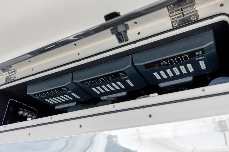 Slide: The Image of Control panel of a 2017 Boston Whaler 420 Outrage boat, featuring multiple switches. - 24