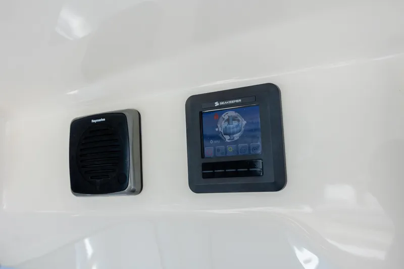 Slide: The Image of Control panel on 2017 Boston Whaler 420 Outrage boat, featuring Raymarine and Seakeeper displays. - 25