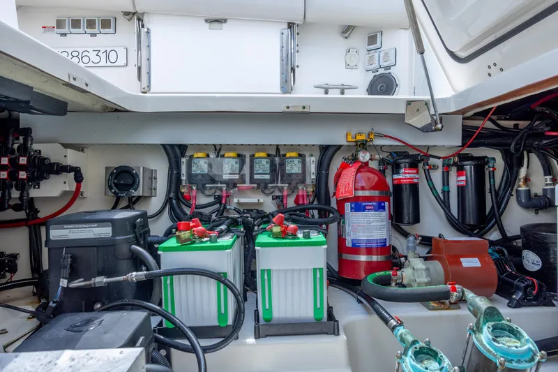 Slide: The Image of Engine compartment of a 2017 Boston Whaler 420 Outrage, featuring batteries and safety equipment. - 51