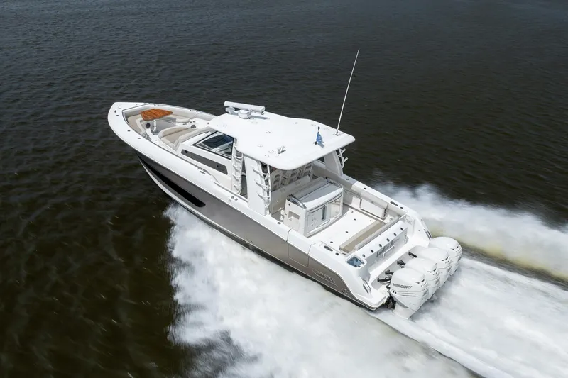 Slide: The Image of 2017 Boston Whaler 420 Outrage cruising on open water, showcasing powerful engines. - 13