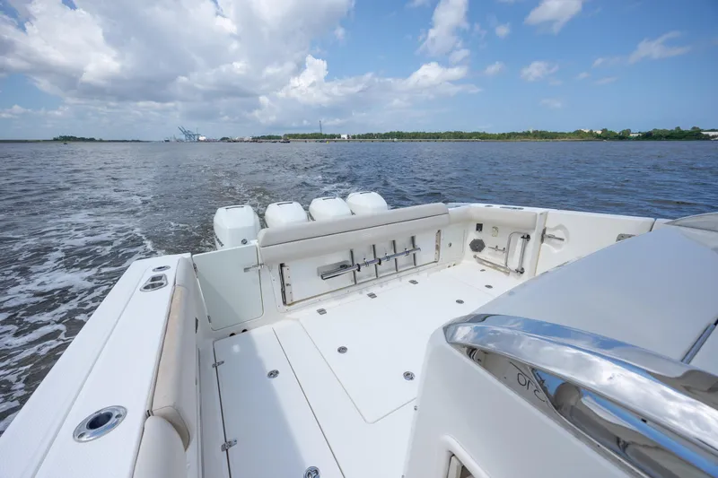 Slide: The Image of 2017 Boston Whaler 420 Outrage boat on open water under a cloudy sky. - 68