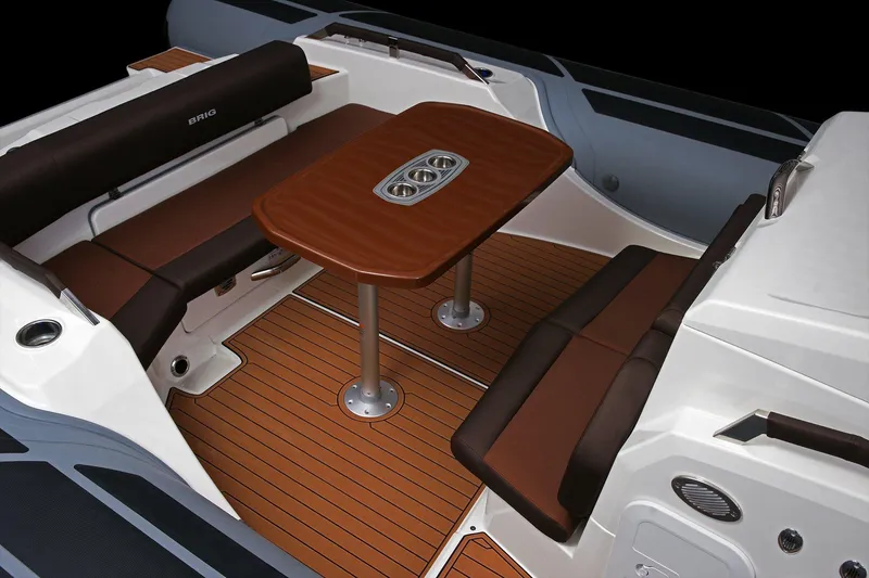 Slide: The Image of Luxurious interior of 2027 Brig Eagle 10 boat with elegant seating and wooden table. - 12