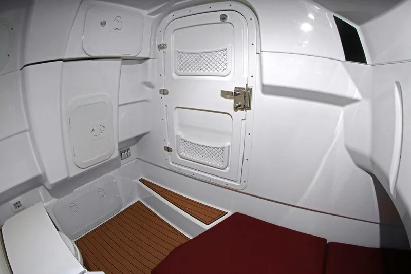 Slide: The Image of Interior cabin of 2027 Brig Eagle 10 boat with white walls and wooden flooring. - 7