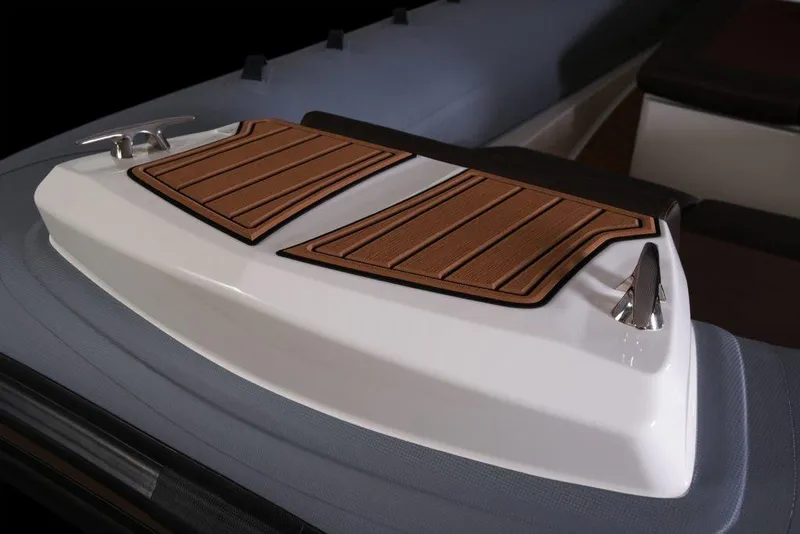 Slide: The Image of 2027 Brig Eagle 10 boat deck with wood-style panels and sleek design. - 4