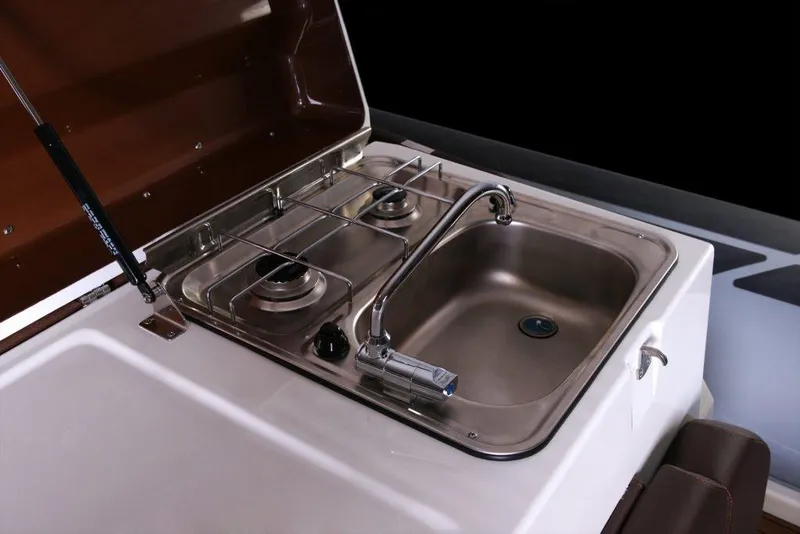 Slide: The Image of Compact kitchen setup on 2027 Brig Eagle 10 boat with sink and dual-burner stove. - 9