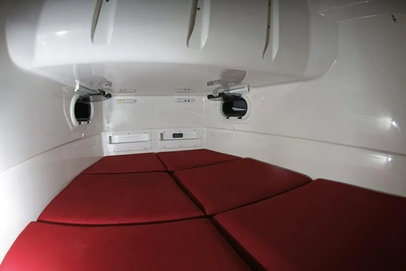 Slide: The Image of Interior cabin of 2027 Brig Eagle 10 boat with red cushions and portholes. - 6