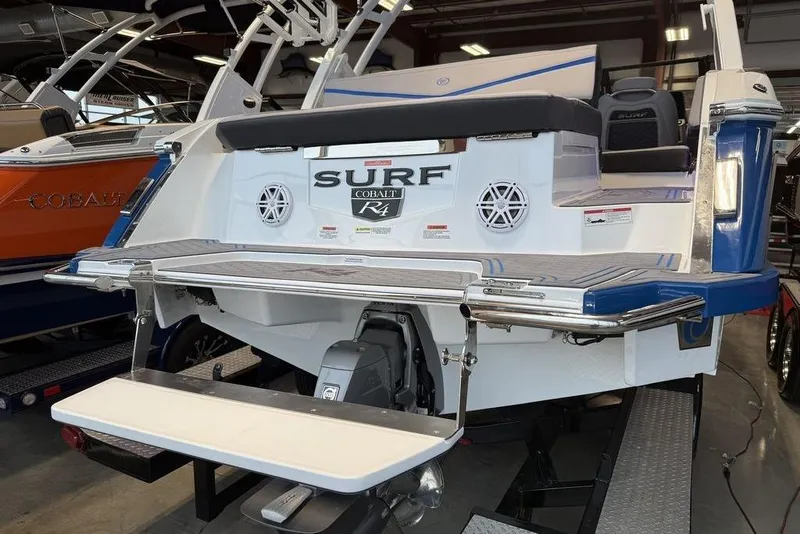 Slide: The Image of 2026 Cobalt R4 Surf boat with swim platform in showroom. - 6