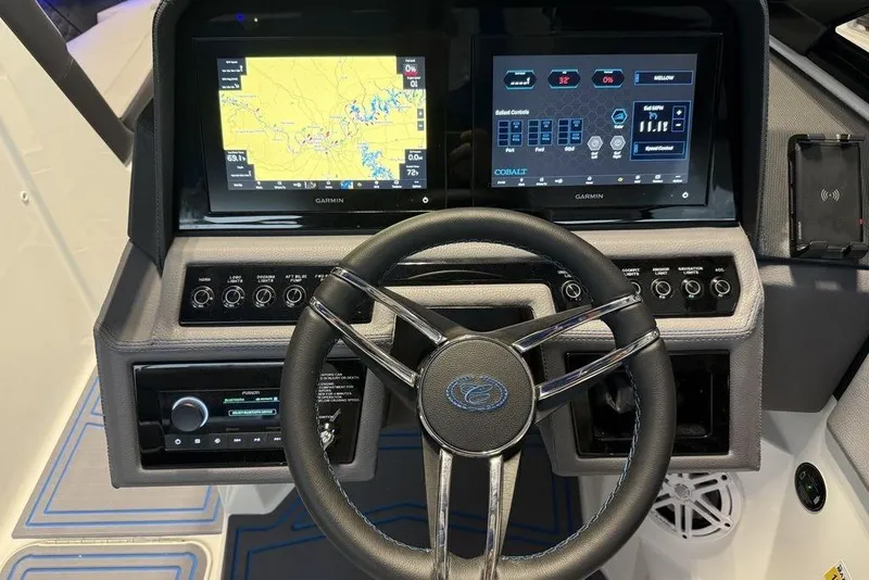 Slide: The Image of Steering wheel and dashboard of 2026 Cobalt R4 Surf boat with dual Garmin displays. - 4