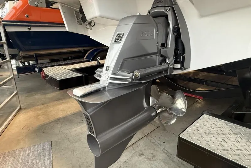 Slide: The Image of 2026 Cobalt R4 Surf boat with advanced propulsion system in a showroom. - 5